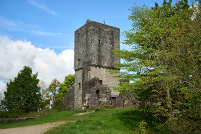 Mugdock Castle - a ruin of Scottish castle behind green trees