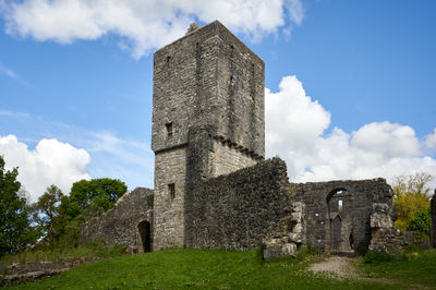 Mugdock Castle - a ruin of Scottish castle in a green park under blue sky