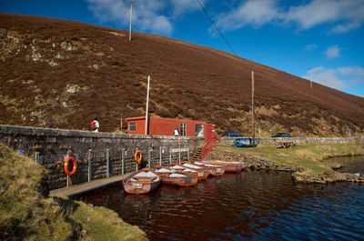 Moored boats on Scottish loch on a sunny day