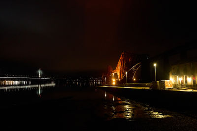 Forth Bridges at night. Red railroad bridge over Firth of Forth