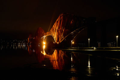 Forth Bridges at night. Red railroad bridge over Firth of Forth