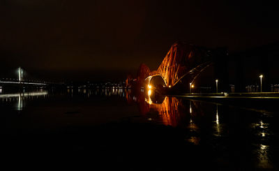 Queensferry @ night. Red railroad bridge over Firth of Forth