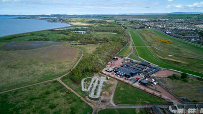 Musselburgh Racecourse from the air. Green field and a seaside