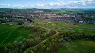 Musselburgh Racecourse from the air. Green field and a seaside