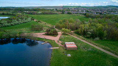 Musselburgh Lagoons. A green field and a small lake