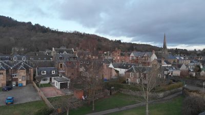 Drone footage. Slowly ascending over the town of Callander, Scotland, Highlands