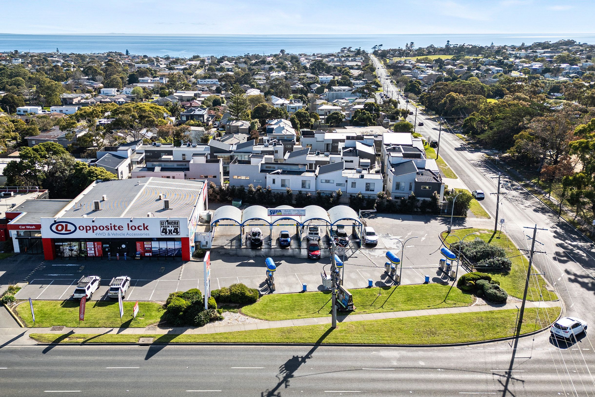 photo of a very busy car wash for sale with car waiting in line to use bays