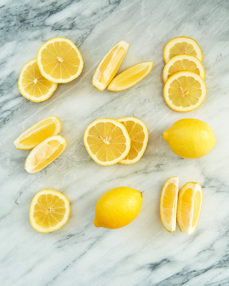 Lemons cut and displayed on a marble counter