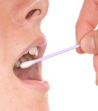 Woman using salivary test swab