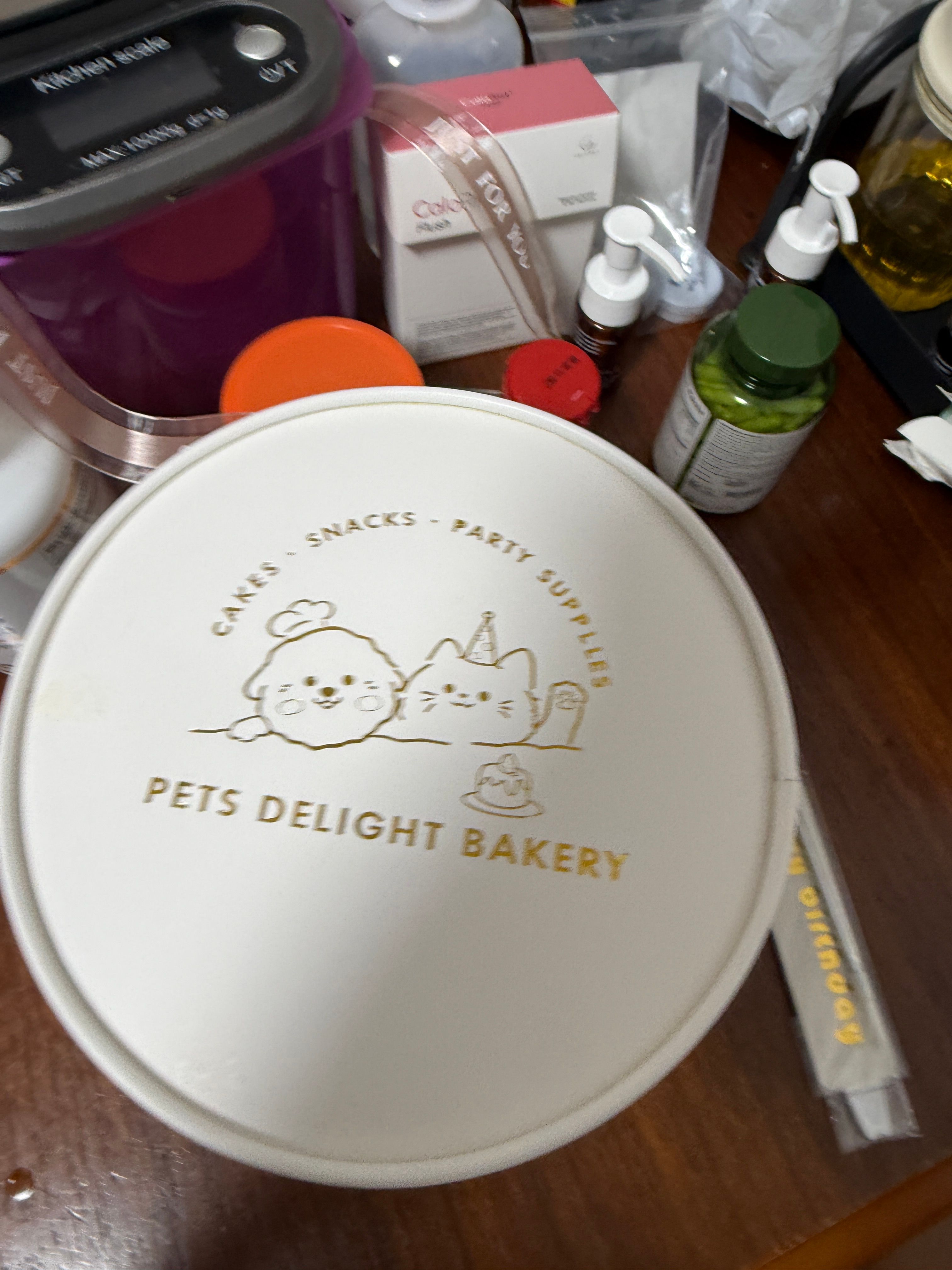 White Pets Delight Bakery cake box lid with gold dog illustrations and Cakes Snacks Party Supplies lettering