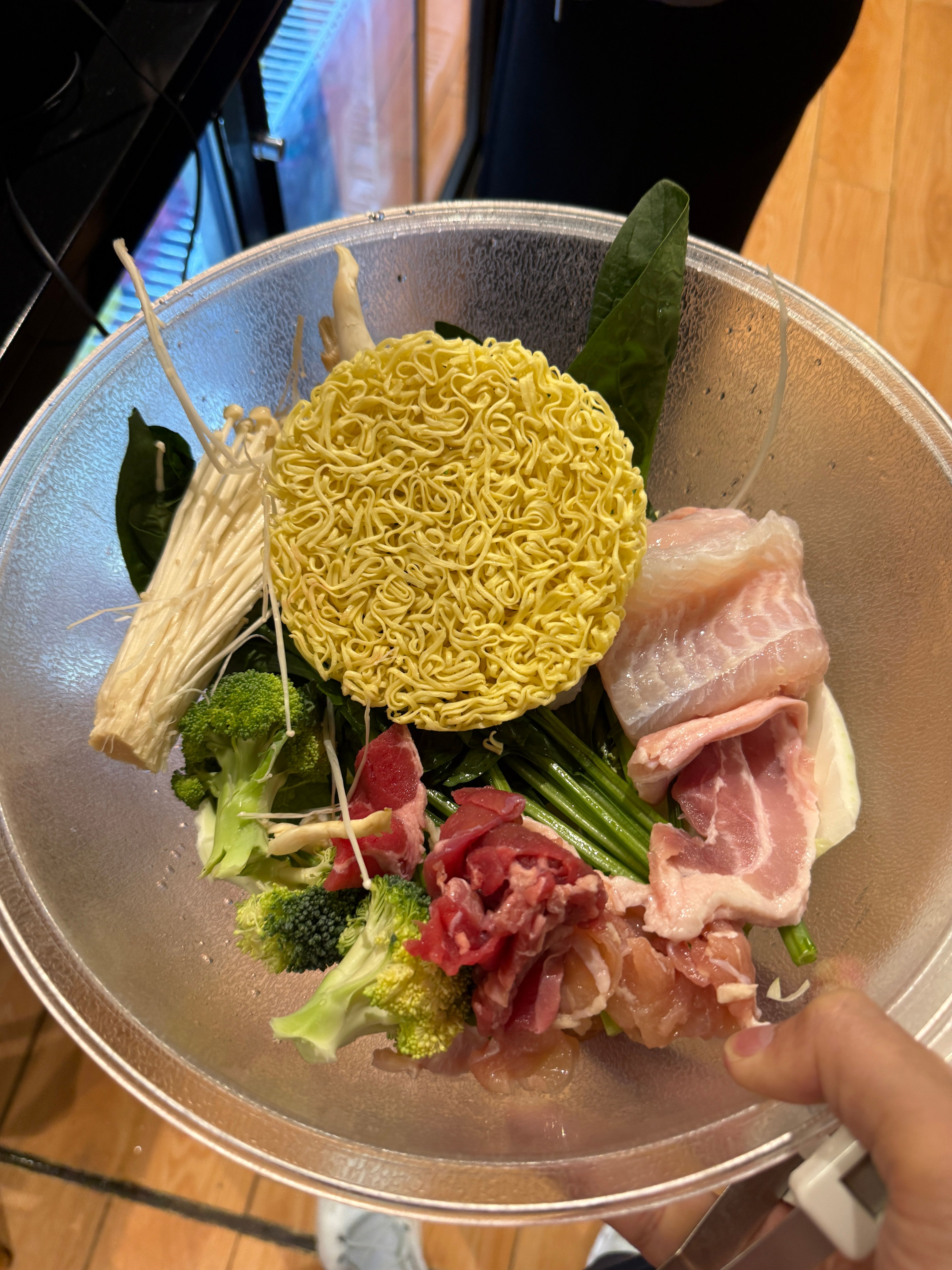 Pick-your-own Yang Guo Fu mala tang ingredients bowl with noodles broccoli enoki meats and fish at Plaza Singapura
