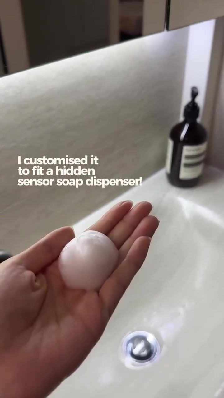 Hand catching foam from a hidden sensor soap dispenser under the mirror cabinet, overlay I customised it to fit a hidden sensor soap dispenser