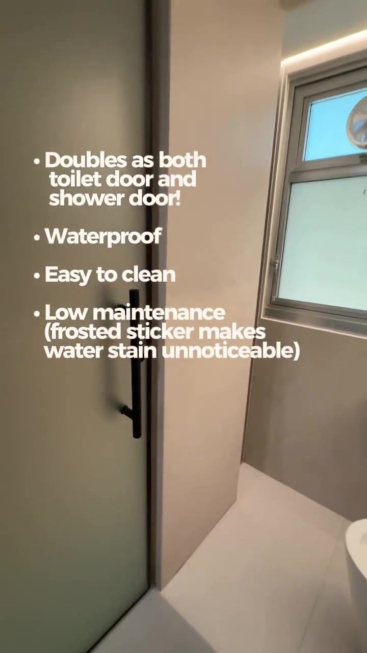 Frosted glass door with thin black frame and long black vertical handle, overlay doubles as toilet and shower door, waterproof, easy to clean, frosted sticker makes water stain unnoticeable