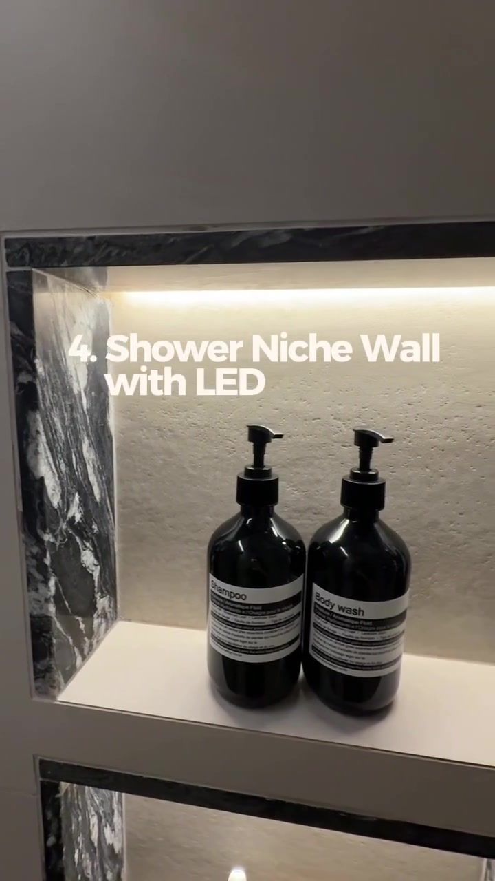 Stacked shower niche with dark veined stone sides, warm LED in the top lip, shampoo and body wash bottles, overlay 4. Shower Niche Wall with LED