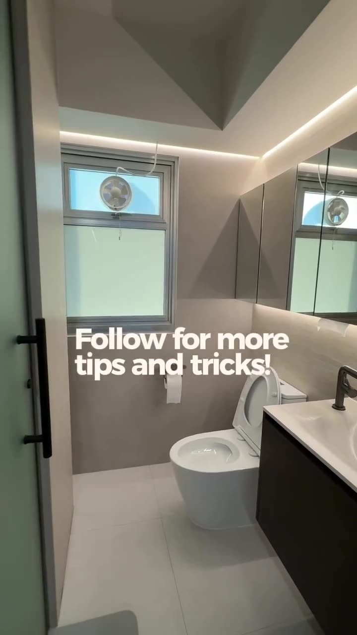 Wide shot of @homemalihom bathroom with toilet, vanity, mirror cabinet, frosted door edge, overlay Follow for more tips and tricks