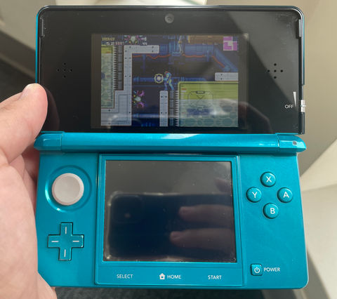 a photo of a 3DS running the Gameboy Advance game Metroid Fusion