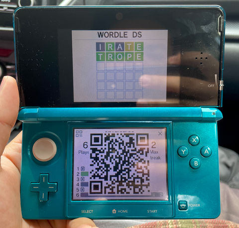 a photo of a 3DS running the Wordle DS app with a qr code on the bottom screen