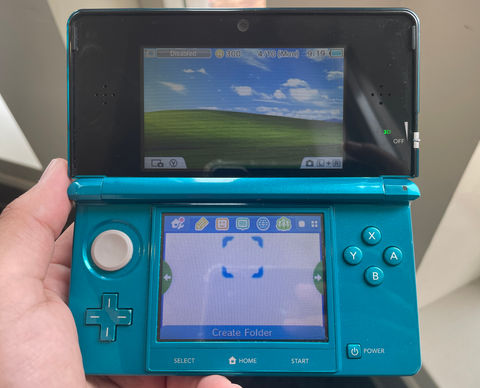 a photo of a 3DS with a Windows XP theme