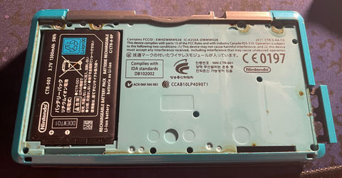 A Nintendo 3DS with the back removed