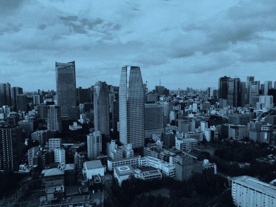 Tokyo skyline beneath a cloudy sky.