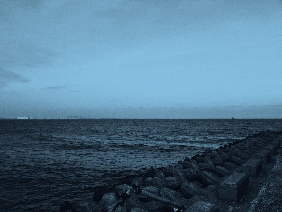 Waves along a concrete waterfront.