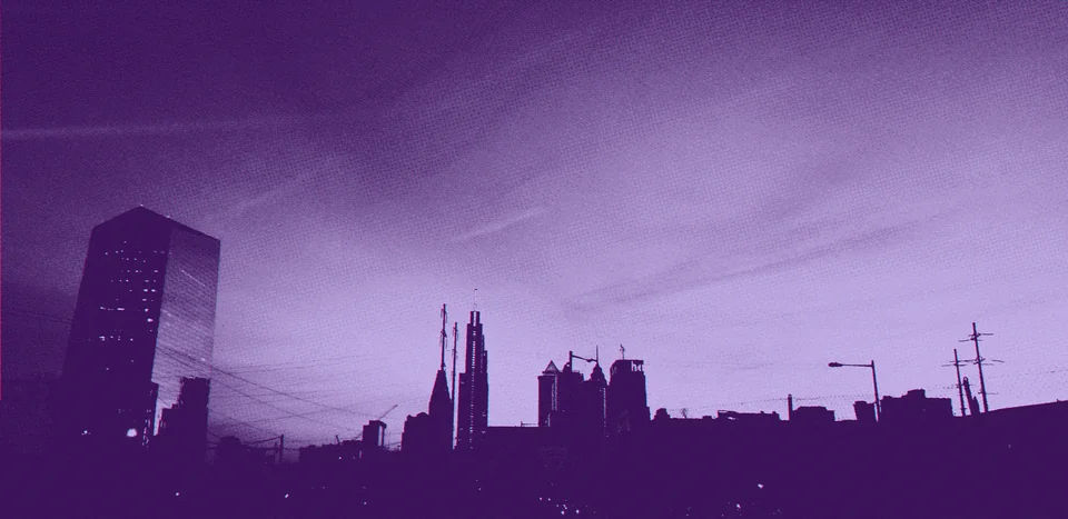 The Philadelphia skyline against a softly lit sky.