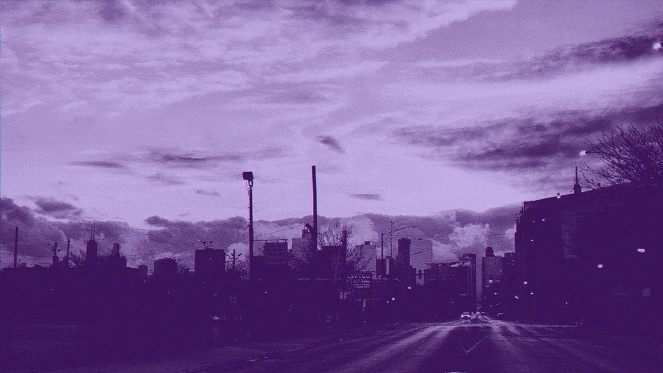 A Chicago street beneath a cloud-streaked sky.
