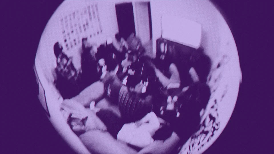 A fisheye view of people gathered in a living room.