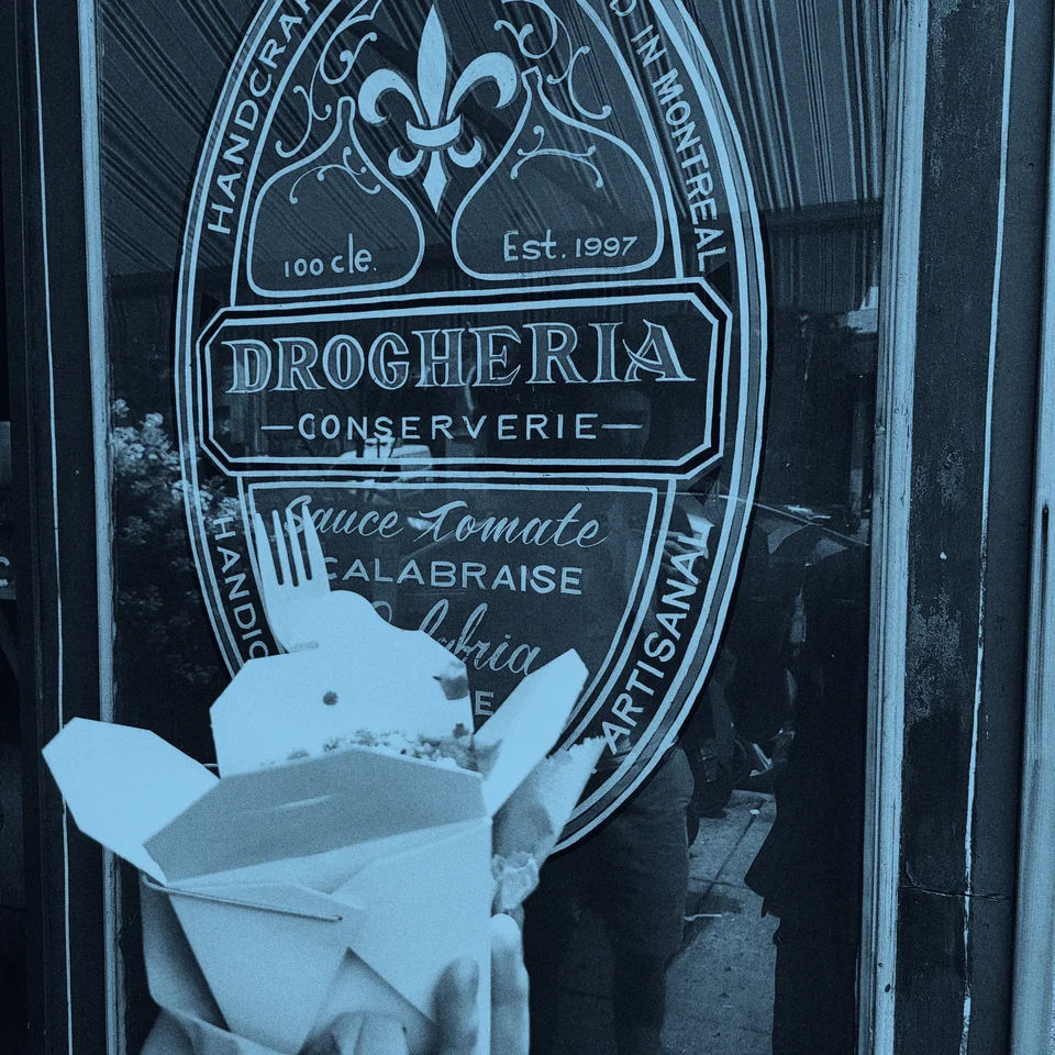 A takeout carton in front of the Drogheria storefront.