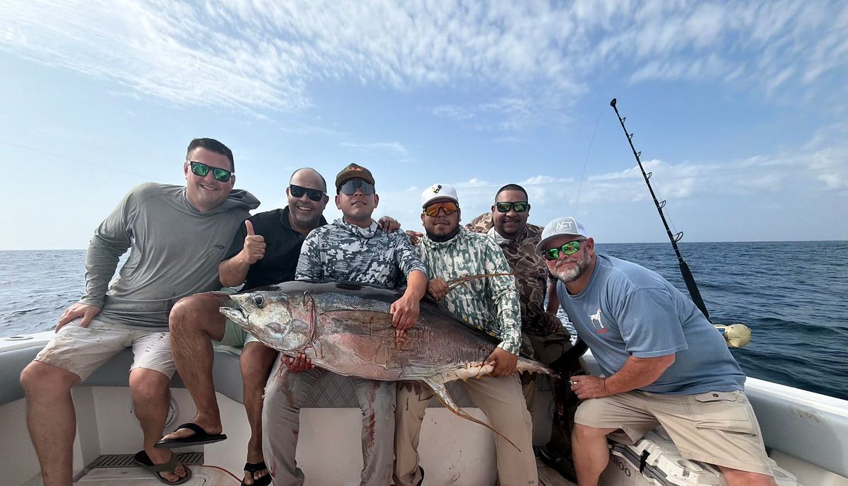 Guys holding up their Yellowfin Tuna during March fishing offshore