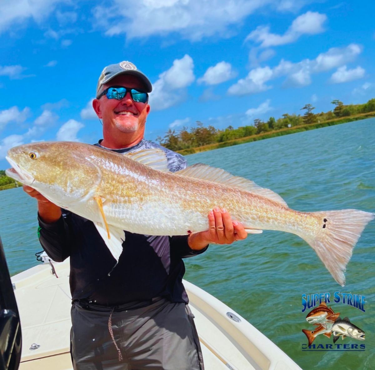 man holding bull redfish