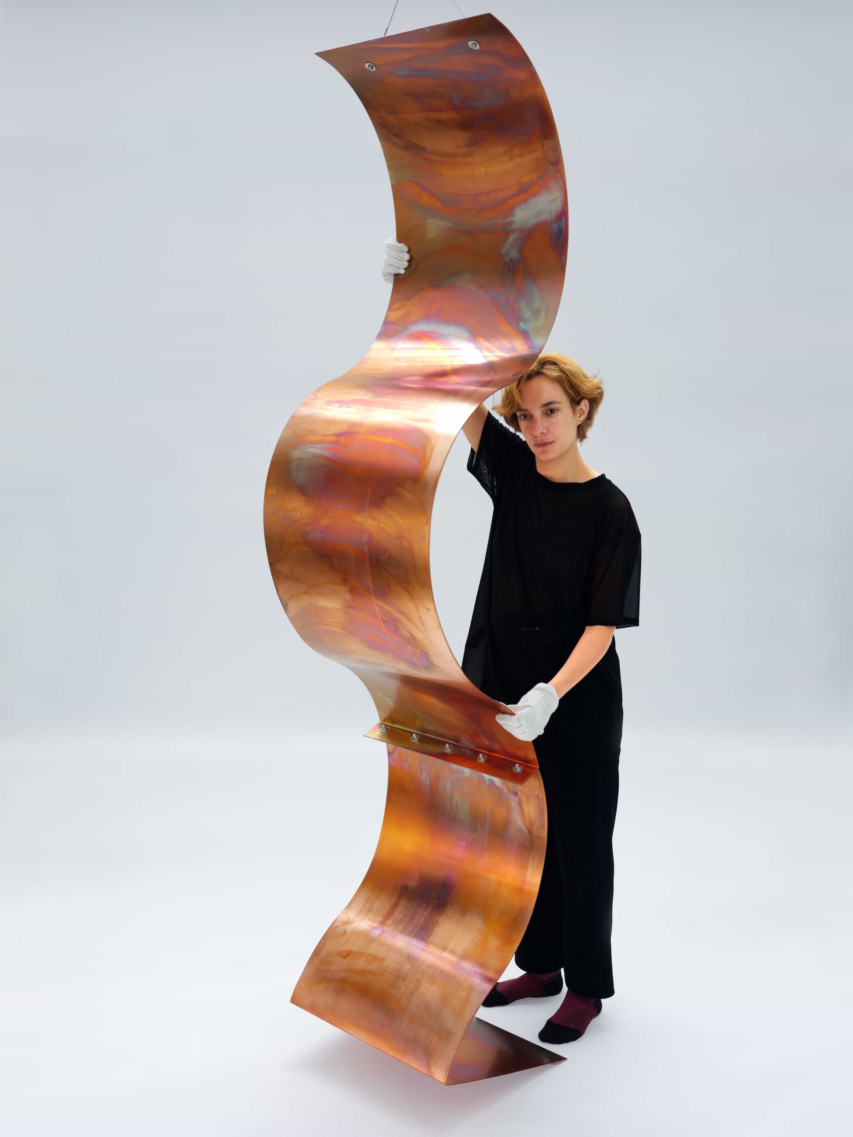 Julie standing next to sculpture 'A Fold - Standing in a Room'