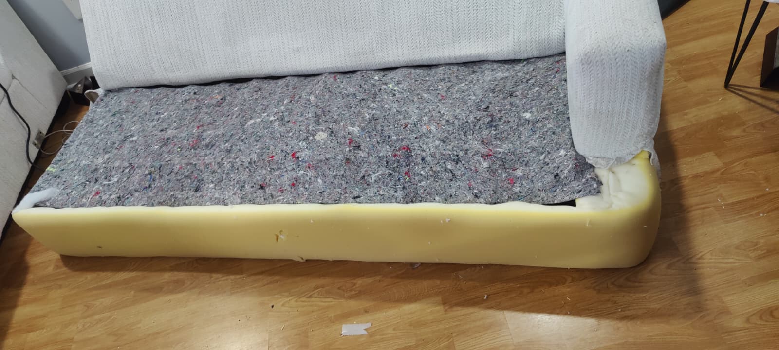 Couch with worn and missing upholstery