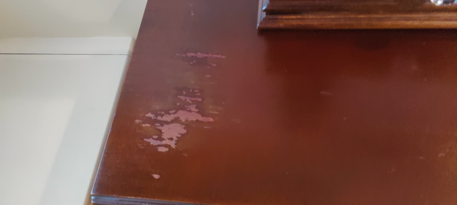 Dresser with chipped wood damage