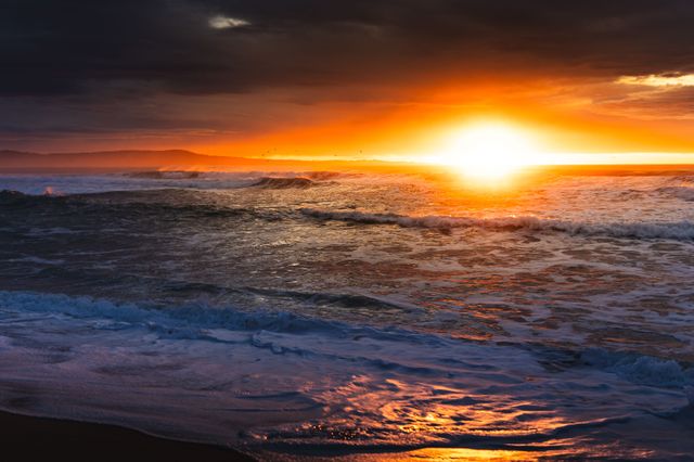 This photo highlights a vivid sunset over the ocean with dramatic storm clouds, perfect for blogs, ads, or creative design projects.