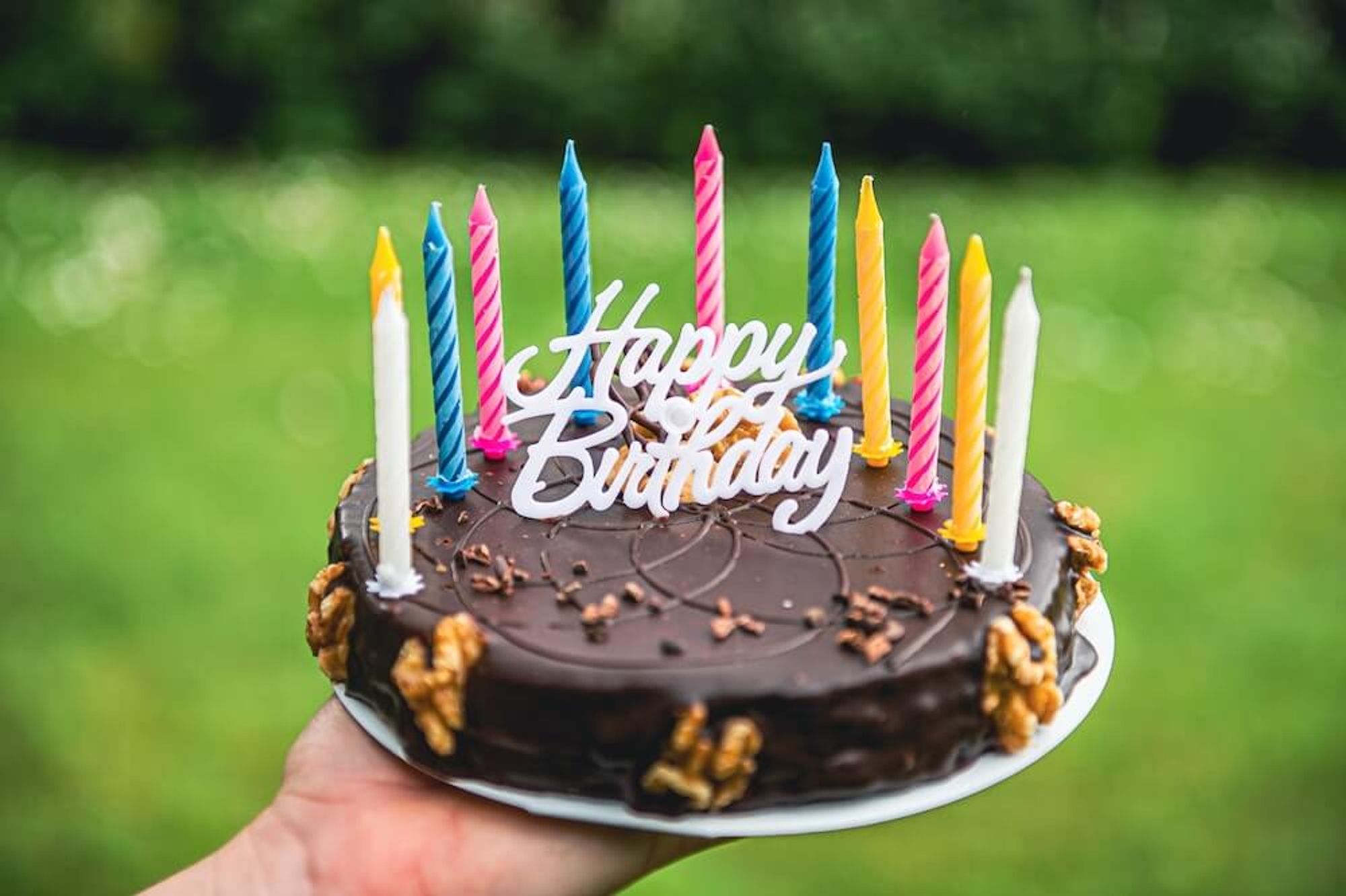 Chocolate birthday cake with colorful candles