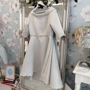 Designer mother of the bride dress. Silver soft satin dress featuring collar and high-low skirt. Made to measure in Glasgow