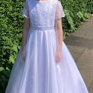 first holy communion dress. Beaded tulle bodice sleeve with soft tulle skirt. Satin bow with beaded detail. Made in Glasgow