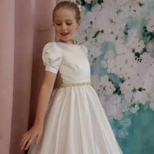 First holy communion dress. Duchesse satin featuring pretty puff sleeves and pearl diamonte belt. Made in Glasgow