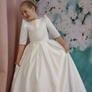 First holy communion dress. Classic duchesse satin with pretty pearl detail on waist and statement bow. Made in Glasgow