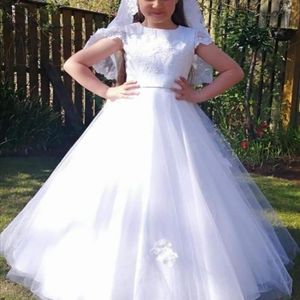 Pretty lace communion bodice with cap sleeve and satin belt/bow. Full circle soft tulle skirt with scattered lace detail. Made to measure in Glasgow