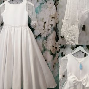 Communion dresses duchess satin gown with delicate pearl detail on waist, sleeves and bow. Made to measure in Glasgow