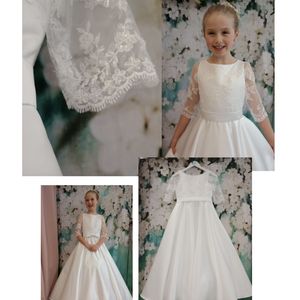 First holy communion dress. Beaded tulle bodice and three-quarter length sleeves with full circular satin skirt. Made in Glasgow