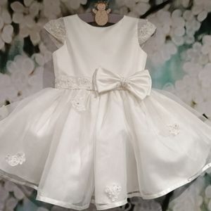 Ivory satin flower girl dress with lace cap sleeve, belt and bow. Made to measure in Glasgow