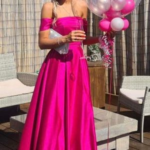 Fuchsia pink strapless ballgown with hidden pockets and cute bow detail on back. Made to measure in Glasgow