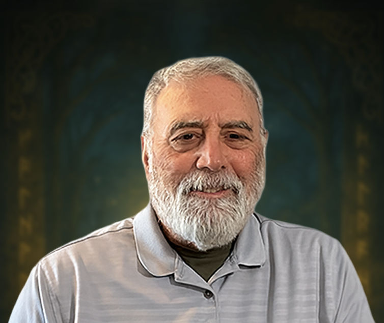 Headshot of fantasy author J.F. Hopper smiling at camera. wearing a light gray polo shirt. He is posed against a softly blurred Celtic-inspired background featuring a golden medallion, reflecting the mythic themes of the Fianna Chronicles.