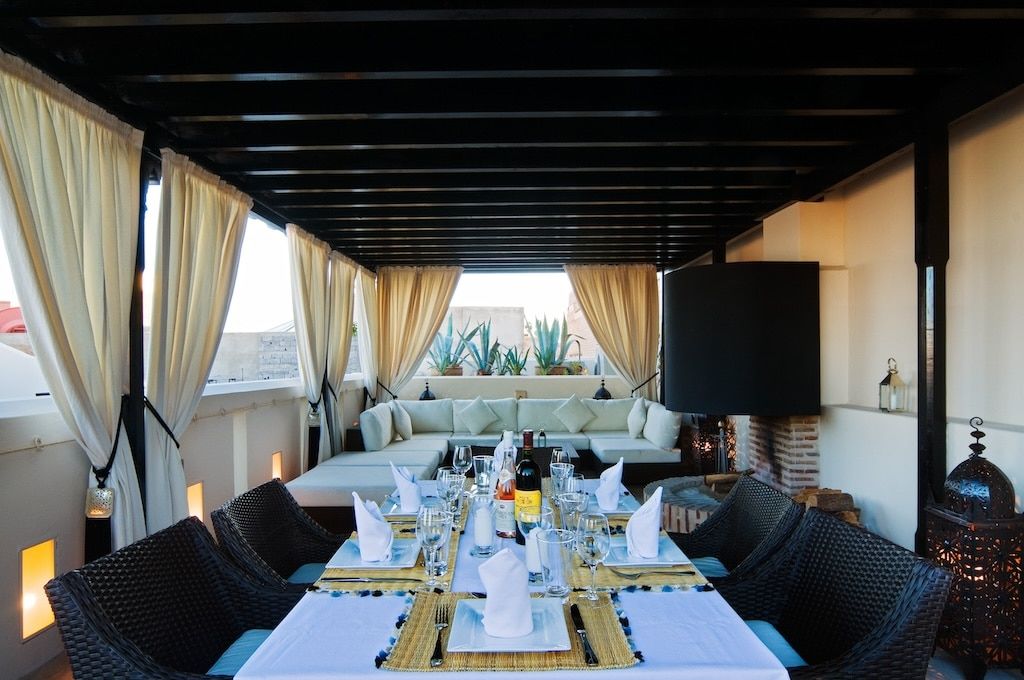 a table set for a fancy dinner showcasing the level of services offered at certain-category riads in Morocco