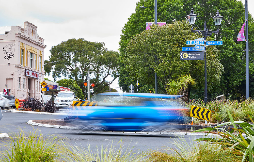 Avondale roundabout looking towards the Holywood cinema with a blue car moving through it. The car is blurry to show it is moving