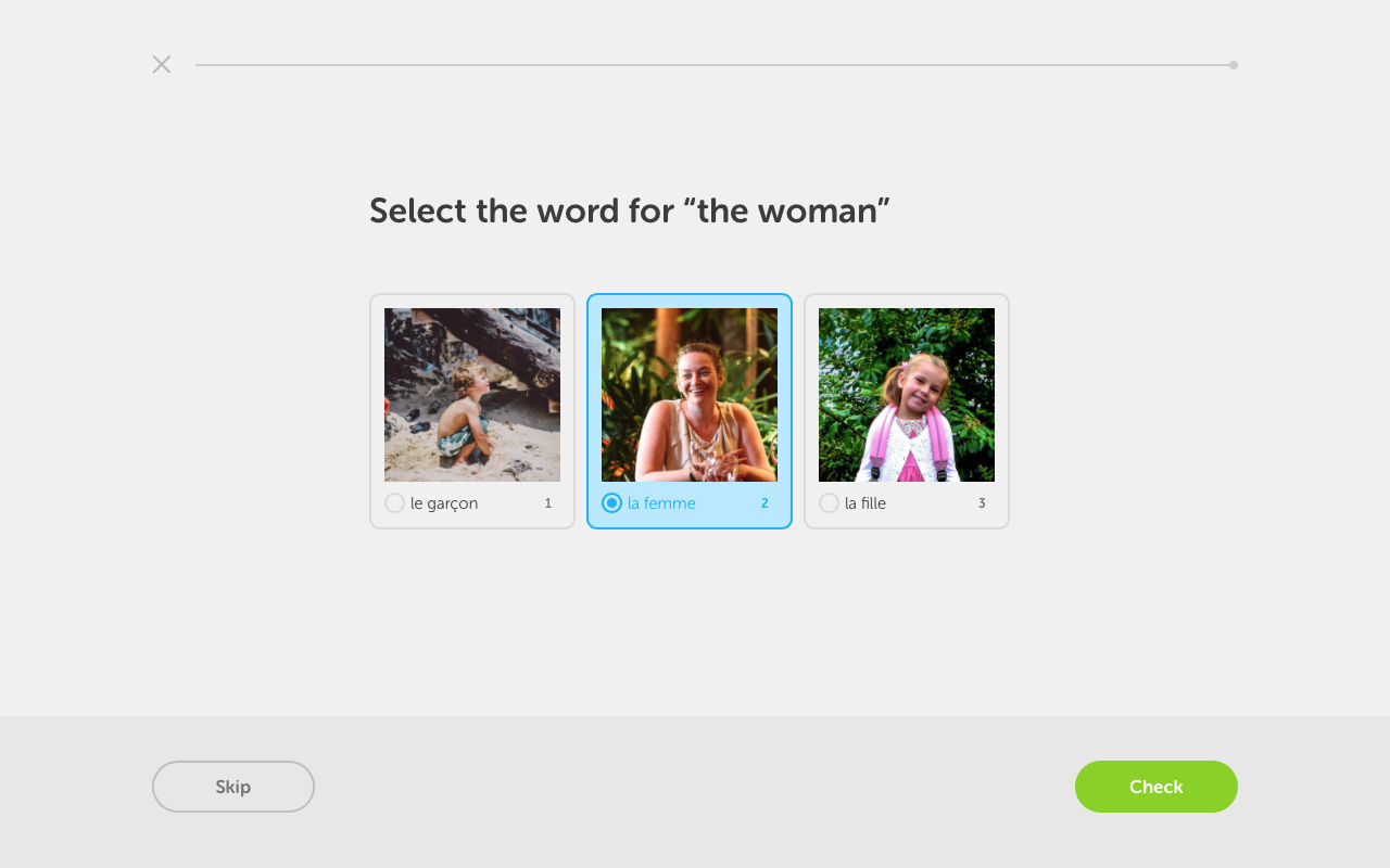 A screen capture of the Duolingo web app showing 3 picture buttons to choose the correct word in French for 'the woman'.