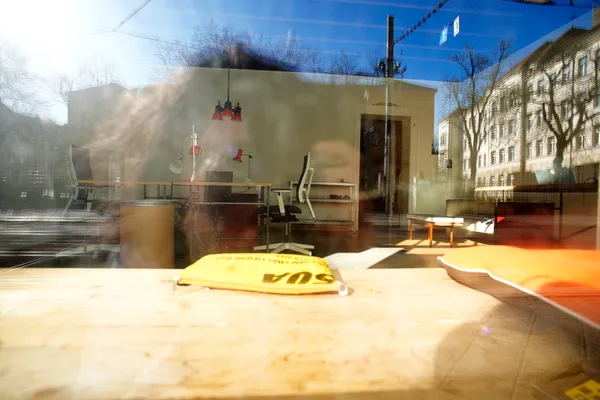 View through the storefront window of KOTEKA coworking space in Leipzig